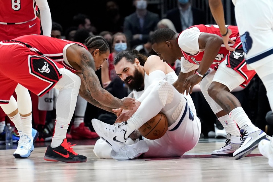 <strong>Memphis Grizzlies' Steven Adams fights to keep the ball from Chicago Bulls' DeMar DeRozan, left, and Javonte Green during the first half of an NBA basketball game Saturday, Feb. 26, 2022, in Chicago.</strong> (AP Photo/Charles Rex Arbogast)