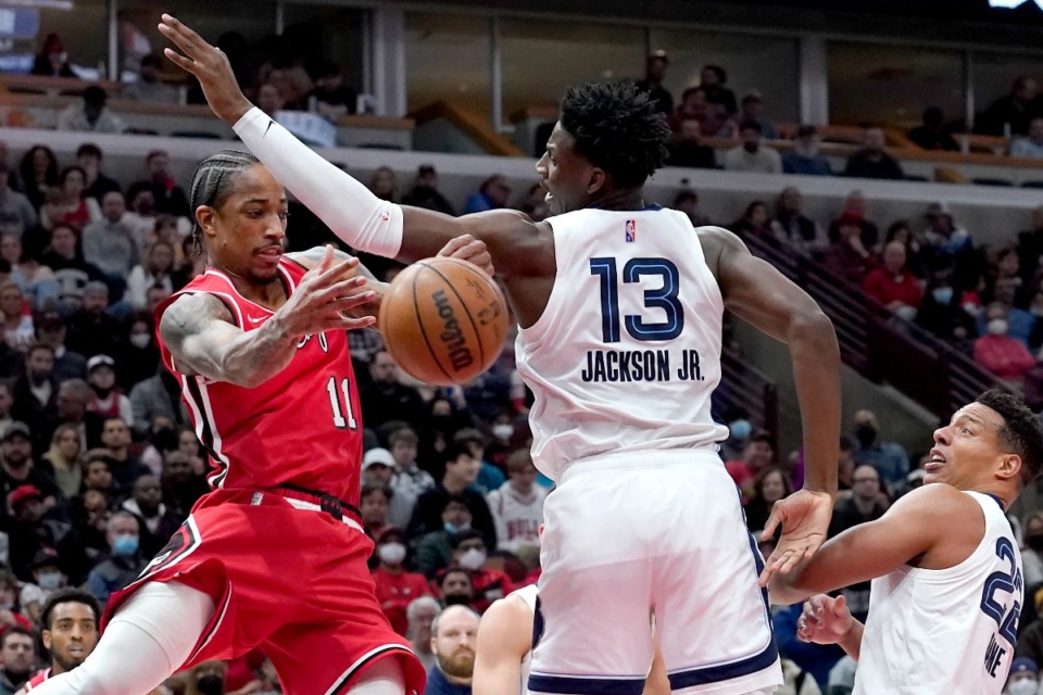 <strong>Memphis Grizzlies' Jaren Jackson Jr. (13) blocks a pass by Chicago Bulls' DeMar DeRozan (11) during the first half of an NBA basketball game Saturday, Feb. 26, 2022, in Chicago.</strong> (AP Photo/Charles Rex Arbogast)