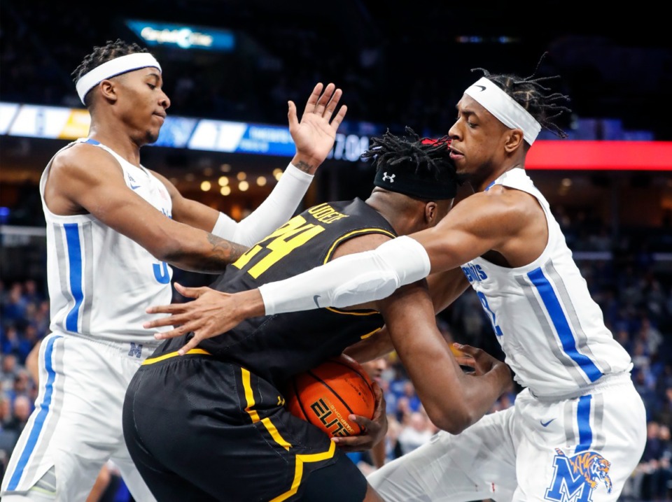 <strong>University of Memphis teammates Landers Nolley II (left) and DeAndre Williams apply defensive pressure to Wichita State forward Morris Udeze (middle) during action on Sunday, Feb. 27, 2022.</strong> (Mark Weber/The Daily Memphian)