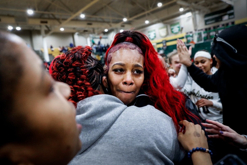 <strong>Arlington head basketball coach Ashley Shields (middle) cries as fans hug her after her team defeated Collierville on Monday, Feb. 28, 2022.</strong> (Mark Weber/The Daily Memphian)