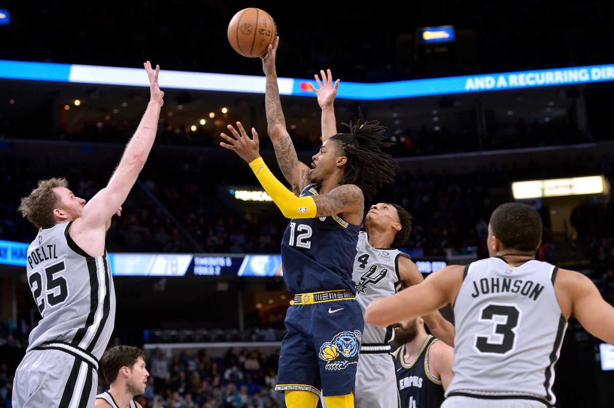 <strong>Memphis Grizzlies guard Ja Morant (12) shoots against San Antonio Spurs center Jakob Poeltl (25) on Feb. 28, 2022, at FedExForum.</strong> (Brandon Dill/AP)