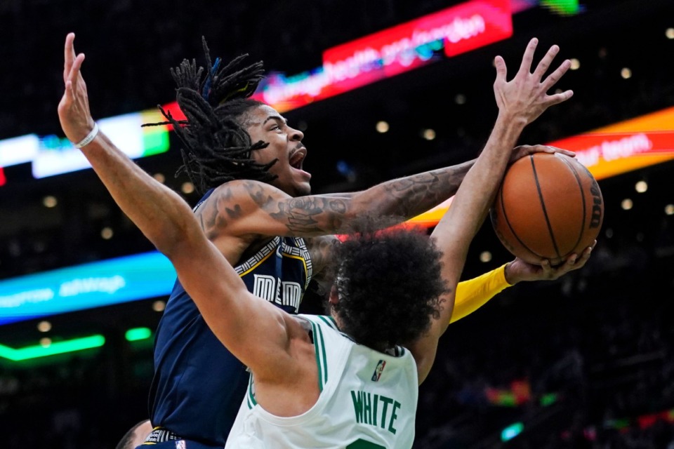 <strong>Memphis Grizzlies guard Ja Morant drives to the basket against Boston Celtics guard Derrick White on Thursday, March 3, in Boston.</strong> (Charles Krupa/Associated Press)