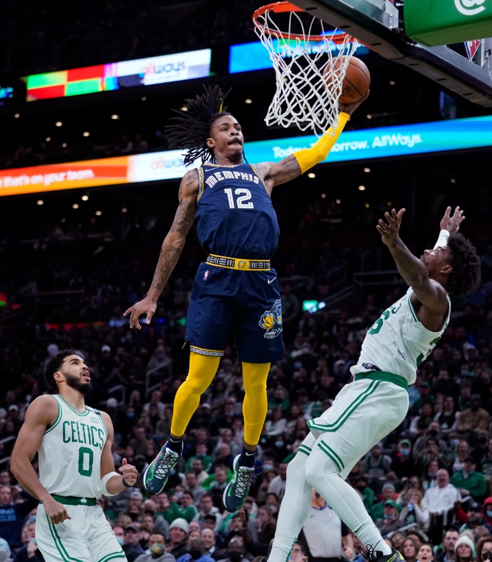 <strong>Memphis Grizzlies guard Ja Morant (12) threads between Boston Celtics guard Marcus Smart, right, and forward Jason Tatum (0) on March 3, 2022, in Boston.</strong> (AP Photo/Charles Krupa)