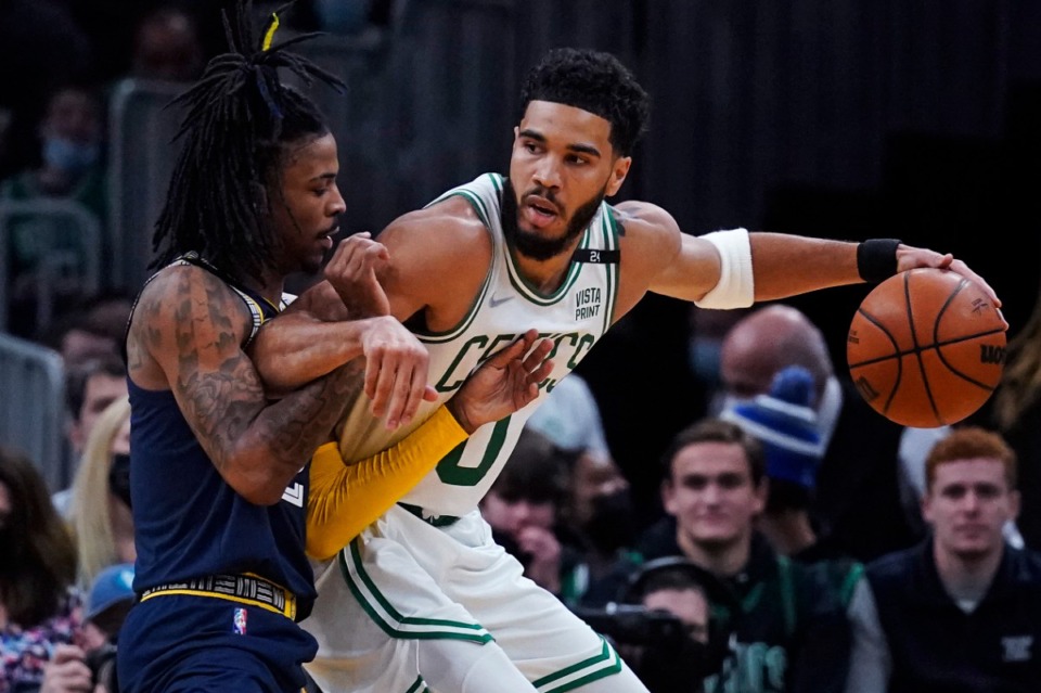 <strong>Boston Celtics forward Jayson Tatum (0) leans on Memphis Grizzlies guard Ja Morant, left, while setting up his drive on March 3, 2022 in Boston.</strong> (Charles Krupa/AP)