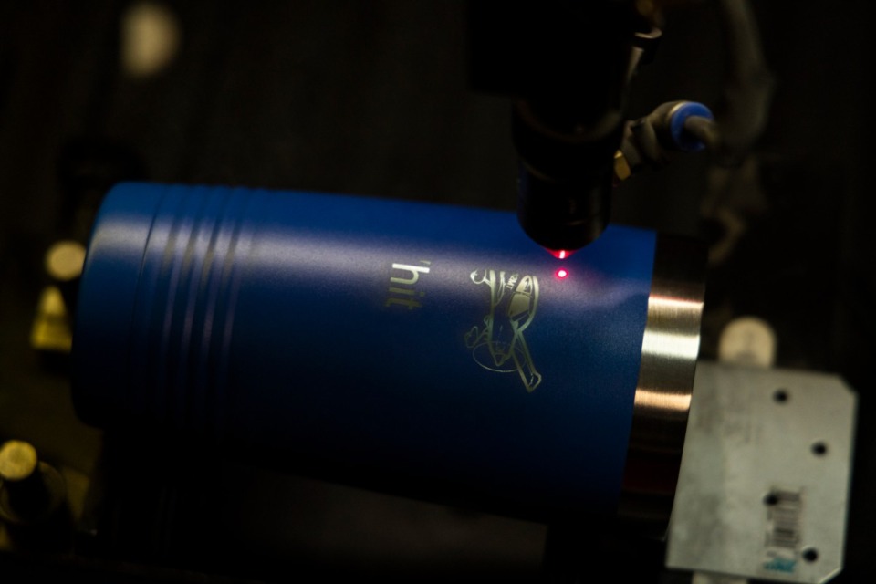 <strong>A laser beam etches the design into a travel mug.</strong> (Brad Vest/The Daily Memphian)