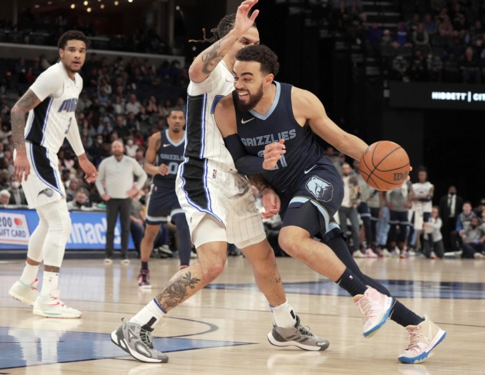 <strong>Memphis Grizzlies' Tyus Jones, right, gets past Orlando Magic's Cole Anthony (50) in the first half of an NBA basketball game Saturday, March 5, 2022.</strong> (AP Photo/Karen Pulfer Focht)