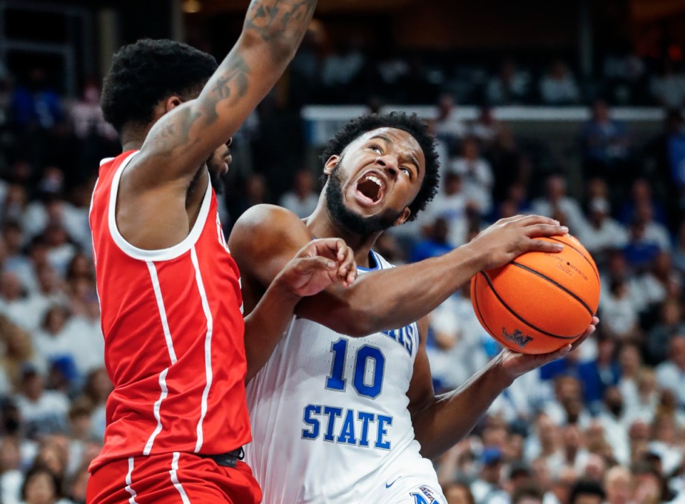 <strong>Memphis guard Alex Lomax (right) drives the lane against Houston defender Jamal Shead (left) during game action on Sunday, March 6, 2022.</strong> (Mark Weber/The Daily Memphian)