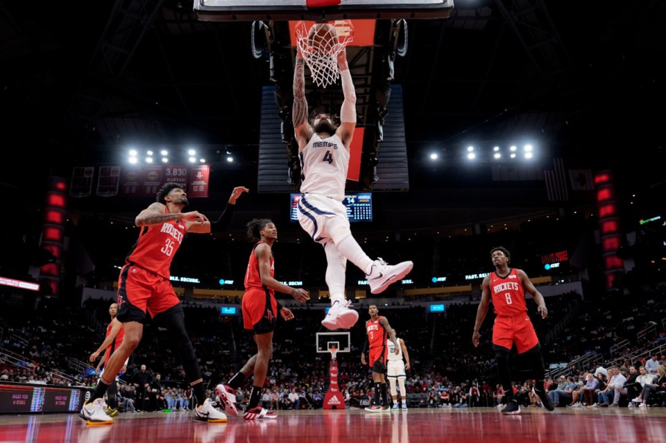 <strong>Memphis Grizzlies' Steven Adams (4) dunks the ball as Houston Rockets' Christian Wood (35), Jalen Green (0) and Jae'Sean Tate (8) watch during the first half of an NBA basketball game Sunday, March 6, 2022, in Houston.</strong> (AP Photo/David J. Phillip)