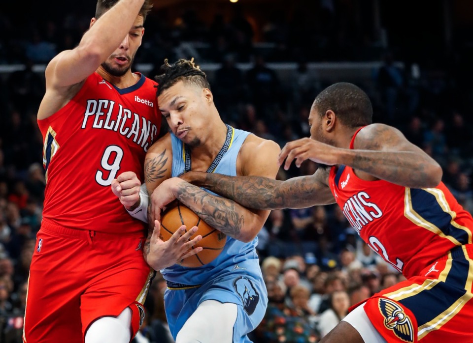 <strong>Memphis Grizzlies forward Brandon Clarke (middle) is fouled by New Orleans&rsquo; Willy Hernangomez (left) on Tuesday, March 8, 2022.</strong> (Mark Weber/The Daily Memphian)