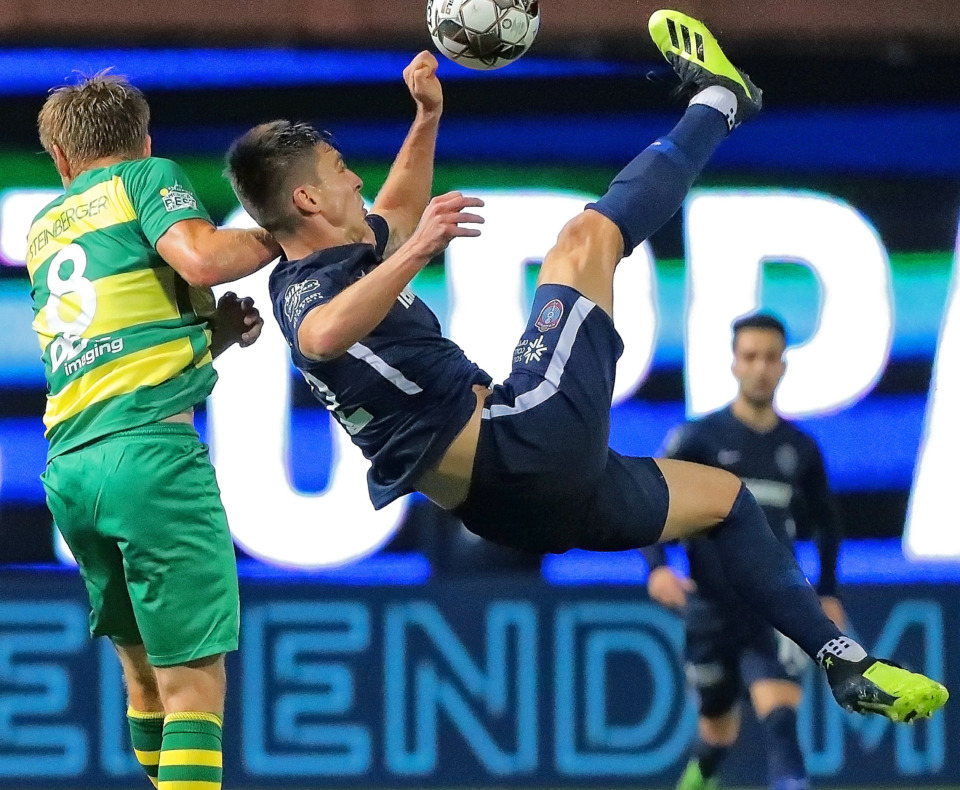 <strong>Wesley Charpie (right) attempts a bicycle kick past Tampa's Zach Steinberger (8) during the 901 FC season opener against the Tampa Rowdies at Autozone Park on March 9, 2019. The Rowdies beat Memphis 1-0 with a penalty kick early in the first half.</strong> (Jim Weber/Daily Memphian)