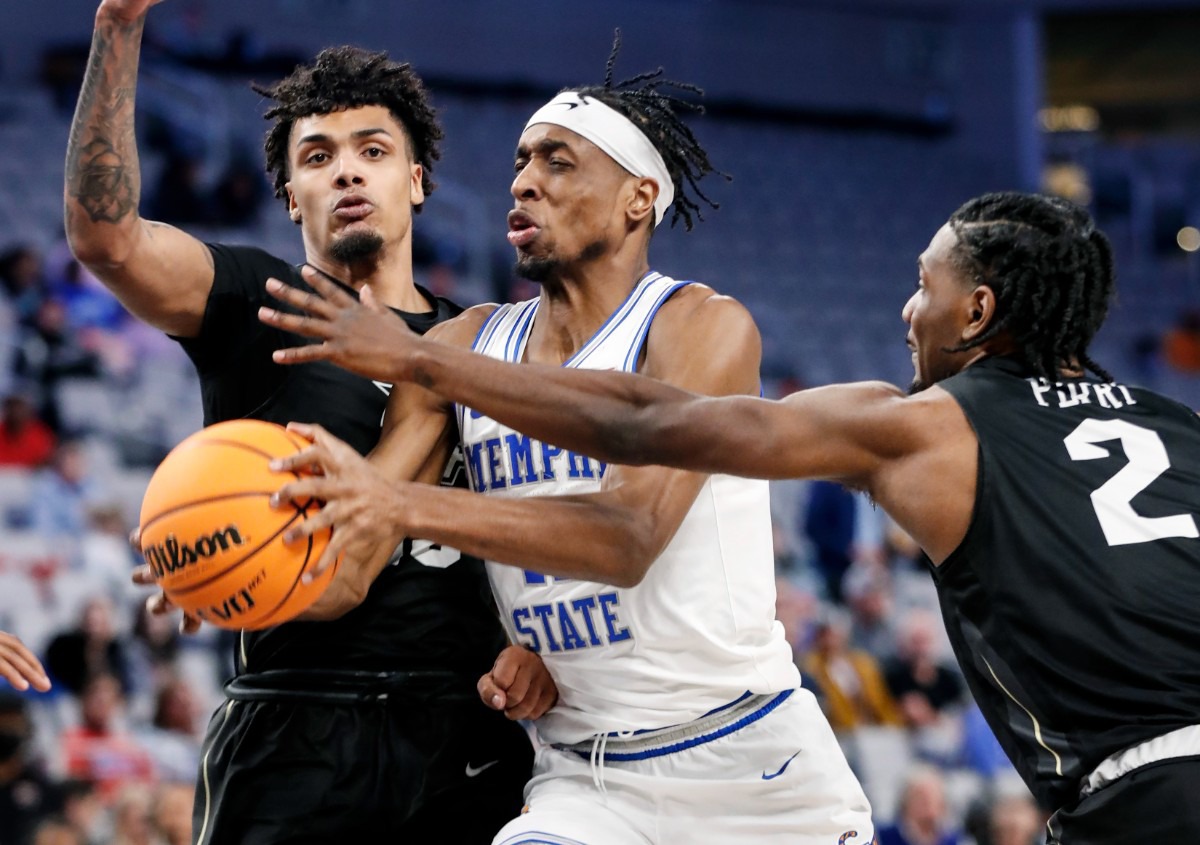 <strong>Tigers guard Landers Nolley II (middle) drives the lane UCF&rsquo;s Brandon Mahan (left) and Darius Perry (right) on Friday, March 11, 2022, in Fort Worth, Texas.</strong> (Mark Weber/The Daily Memphian)