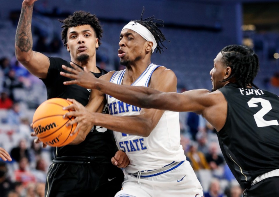 <strong>Tigers guard Landers Nolley II (middle) drives the lane against UCF&rsquo;s Brandon Mahan (left) and Darius Perry (right) on Friday, March 11, 2022, in Fort Worth, Texas.</strong> (Mark Weber/The Daily Memphian)