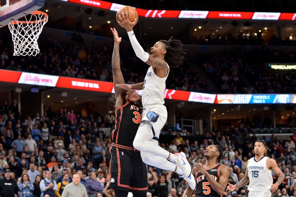 <strong>Memphis Grizzlies guard Ja Morant dunks against New York Knicks forward Julius Randle on March 11.</strong> (Brandon Dill/AP)