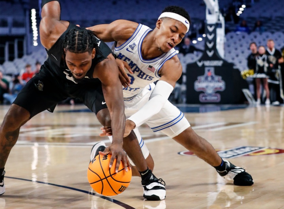 <strong>Tigers defender Landers Nolley II (right) battles UCF guard Darius Perry (left) for a loose ball on Friday, March 11, 2022, in Fort Worth, Texas.</strong> (Mark Weber/The Daily Memphian)