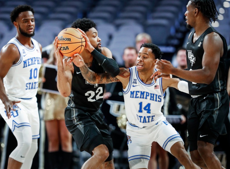<strong>The Tigers&rsquo; Tyler Harris (middle right) looks to knock the ball away from UCF guard Darin Green Jr. (middle left) on Friday, March 11, 2022, in Fort Worth, Texas.</strong> (Mark Weber/The Daily Memphian)