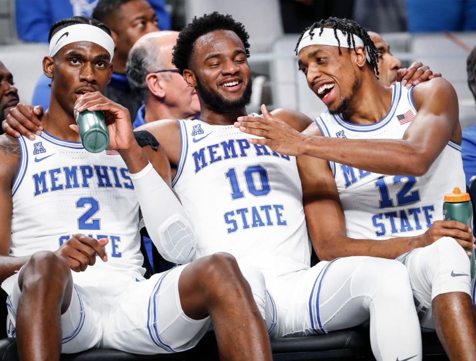 <strong>Tigers Alex Lomax (middle) and DeAndre Williams (right) joke on the bench during the game against UCF on Friday, March 11, 2022, in Fort Worth, Texas.</strong> (Mark Weber/The Daily Memphian)
