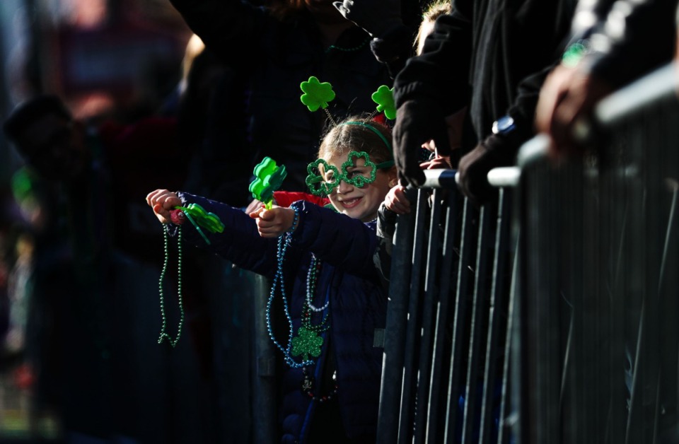 <strong>A young child celebrates catching a bead necklace during the 49th annual St. Patrick's Day Parade on Beale Street March 12, 2022.</strong> (Patrick Lantrip/Daily Memphian)