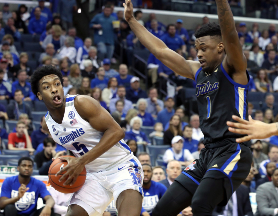 <strong>Universeity of Memphis guard Kareem Brewton (5) grabs a rebound as Tulsa Golden Hurricanes' Martin Igbanu (1) defends during the first half of a game at FedExForum on Saturday, March 9, 2019.</strong> (Karen Pulfer Focht/Special to The Daily Memphian)