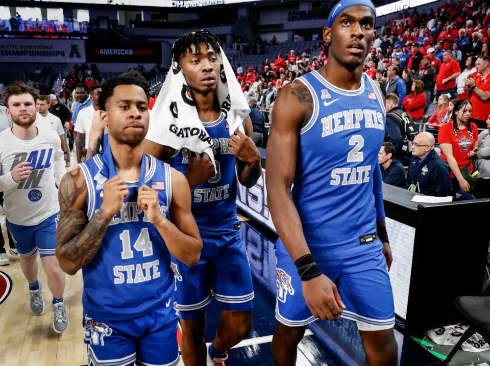 <strong>Tigers teammates (left to right) Tyler Harris, Earl Timberlake and Jalen Duren walk off the court after falling to Houston during action on Sunday, March 13, 2022 in the AAC Championship game in Fort Worth, Texas.</strong> (Mark Weber/The Daily Memphian)