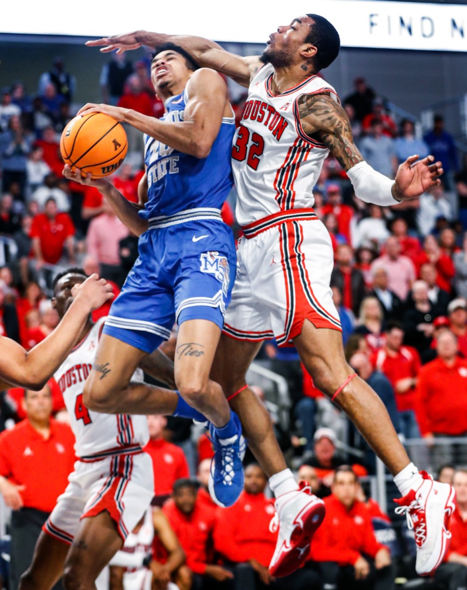 <strong>Tigers forward Josh Minott (left) is fouled by Houston defender Fabian White Jr. (right) during action on Sunday, March 13, 2022 in the AAC Championship game in Fort Worth, Texas.</strong> (Mark Weber/The Daily Memphian)