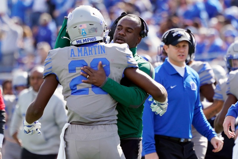 <strong>Memphis running back Asa Martin (28) is congratulated by running backs coach Anthony Jones after Martin scored a touchdown against SMU in the second half of an NCAA college football game Saturday, Nov. 6, 2021, in Memphis, Tennessee</strong>. (AP Photo/Mark Humphrey)