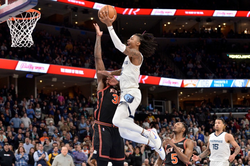 <strong>Memphis Grizzlies guard Ja Morant dunks against New York Knicks forward Julius Randle in the second half of an NBA basketball game Friday, March 11, 2022, in Memphis, Tennessee.</strong> (AP Photo/Brandon Dill)