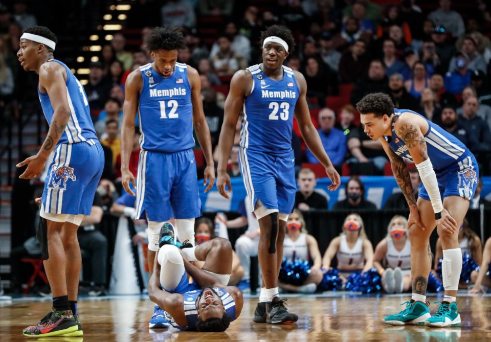 <strong>Tigers guard Alex Lomax (bottom) winces in pain as his teammates look on during the game against Boise State on Thursday, March 17, 2022, in Portland, Oregon.</strong> (Mark Weber/The Daily Memphian)