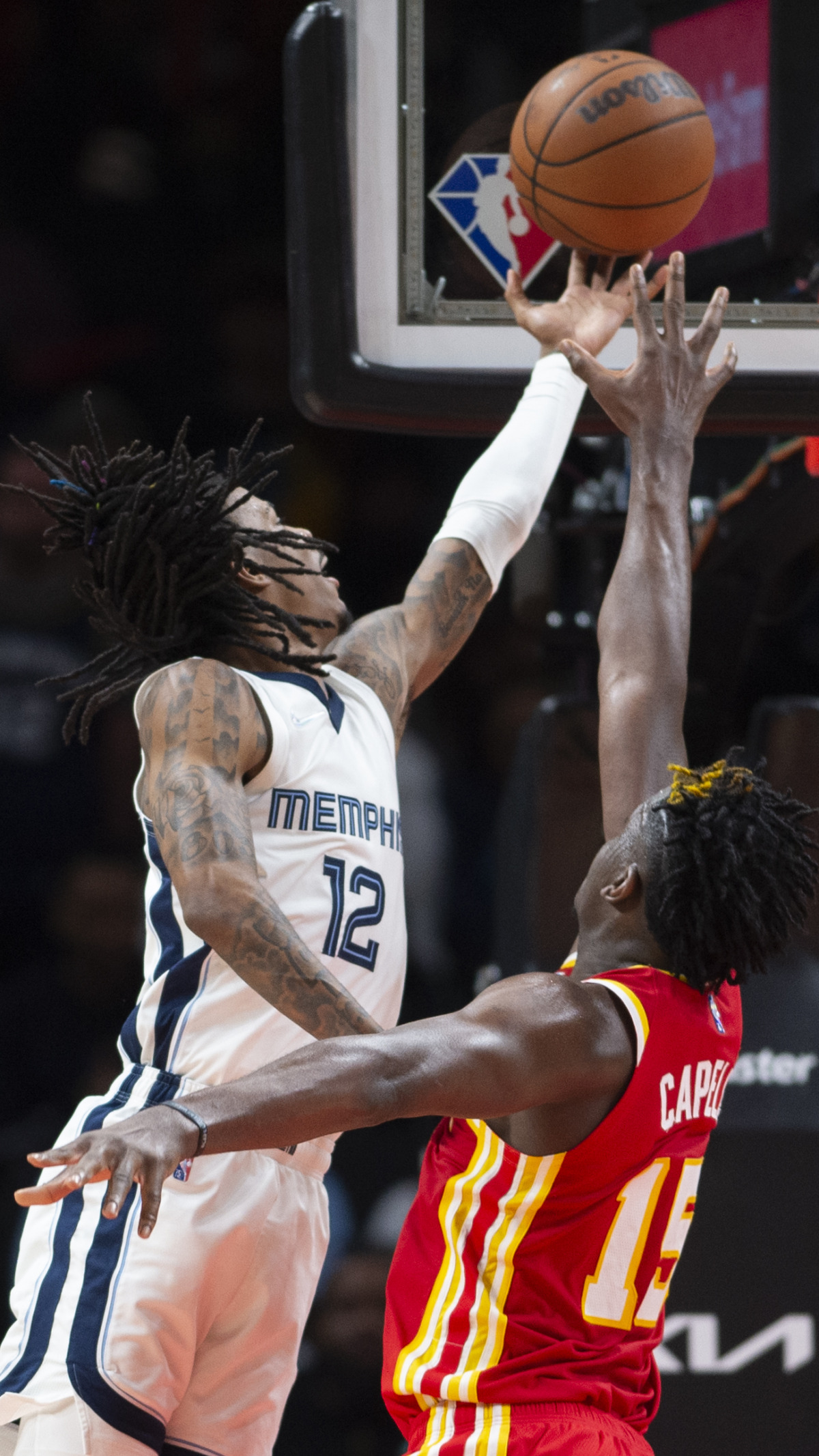 <strong>Memphis Grizzlies guard Ja Morant (12) scores over Atlanta Hawks center Clint Capela (15) on March 18, 2022, in Atlanta.</strong>&nbsp;<strong>Morant scored 29 points.</strong> (Hakim Wright Sr./AP)