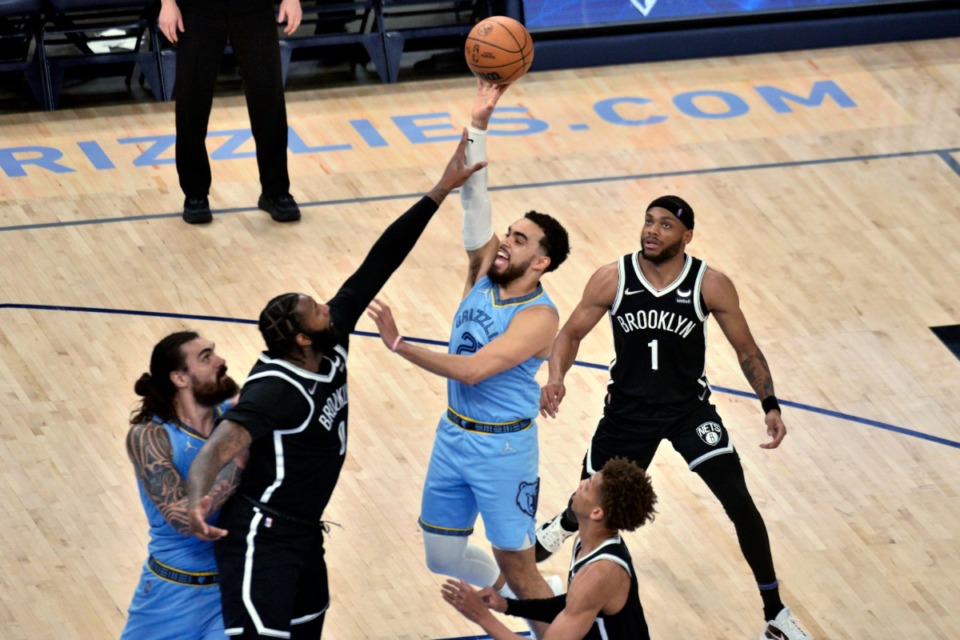 <strong>Memphis Grizzlies guard Tyus Jones (21) shoots against Brooklyn Nets center Andre Drummond (0)&nbsp;on March 23, 2022, at FedExForum.</strong> (Brandon Dill/AP)
