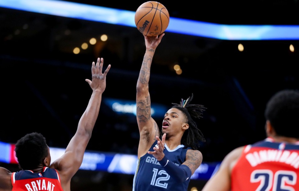 <strong>Memphis Grizzlies guard Ja Morant (12) shoots a floater during a Jan. 29, 2022 game against the Washington Wizards.&nbsp;Morant has now missed three straight games with the knee injury.&nbsp;</strong> (Patrick Lantrip/The Daily Memphian file)