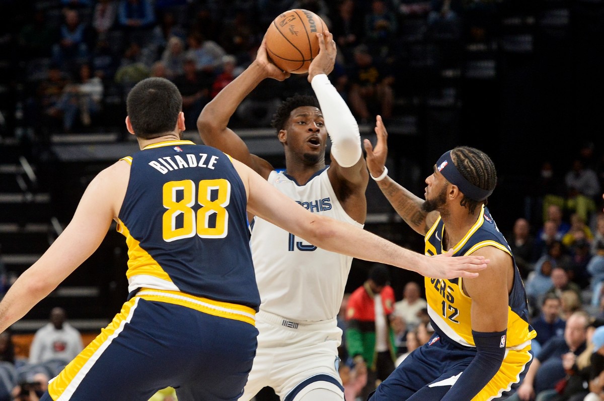 <strong>Memphis Grizzlies forward Jaren Jackson Jr. (13) handles the ball against Indiana Pacers forward Oshae Brissett (12) and center Goga Bitadze (88)</strong>&nbsp;<strong>on March 24, 2022, at FedExForum.</strong> (Brandon Dill/AP)