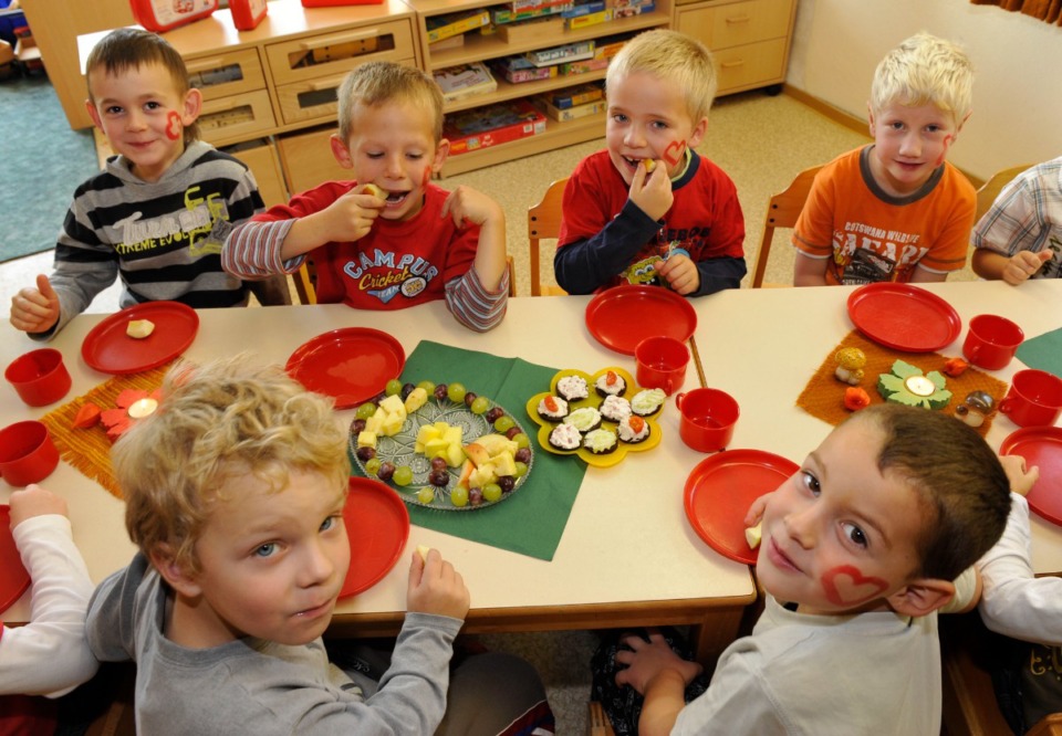 <strong>All involved say child care costs too much and workers are paid too little, causing parents to miss work, which in turn decreases their productivity at work.</strong> (AP Photo file/Matthias Rietschel)