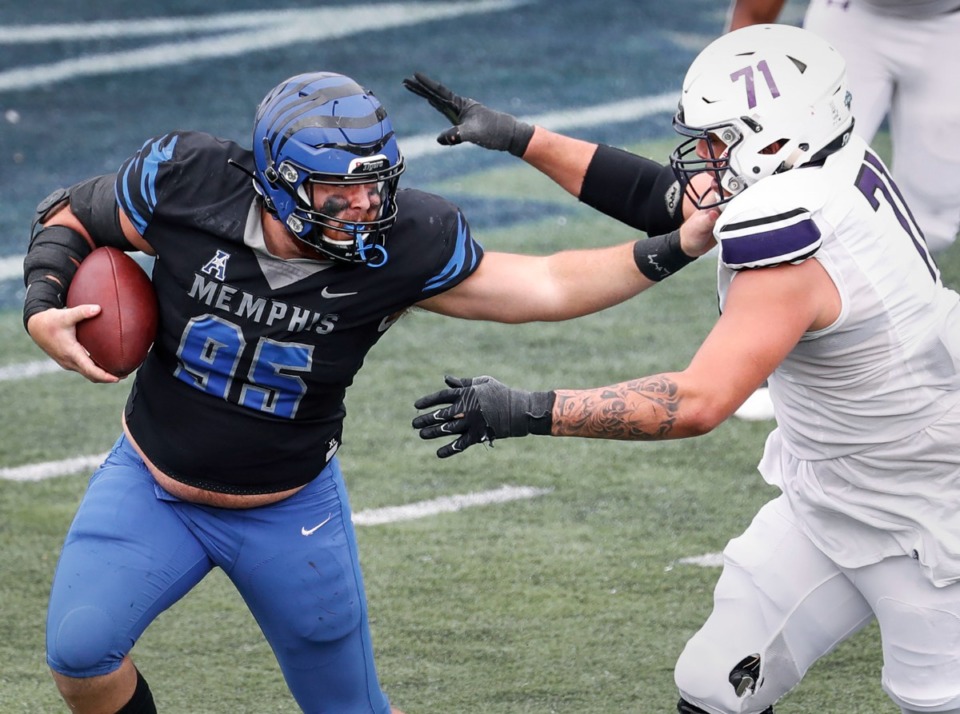 <strong>Memphis defensive lineman John Cartwright (left) tries to fight a tackle by Stephen F. Austin lineman Zach Ingram (right) after grab an interception during action on Saturday, Nov. 21, 2020. Cartwright and &nbsp;offensive lineman Evan Fields have medically retired.</strong> (Mark Weber/The Daily Memphian file)