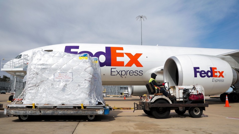 <strong>A FedEx driver ferries crates filled with humanitarian aid to be loaded on a plane and shipped to Ukraine, Saturday, March 26.</strong> (Patrick Lantrip/The Daily Memphian)