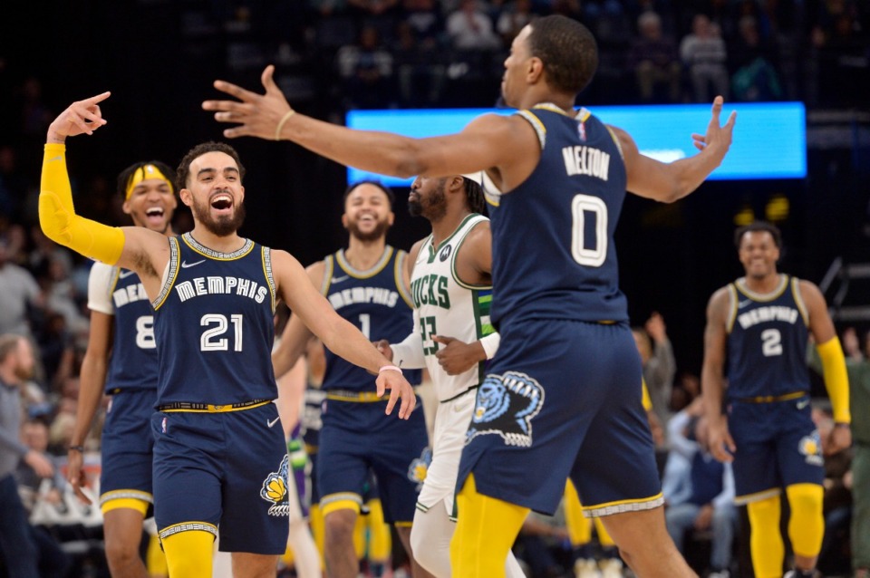 <strong>Memphis Grizzlies guard Tyus Jones (21) reacts after fellow guard De'Anthony Melton (0) scored a three-point basket in the second half of an NBA basketball game against the Milwaukee Bucks, Saturday, March 26, 2022, at FedExForum.</strong> (AP Photo/Brandon Dill)