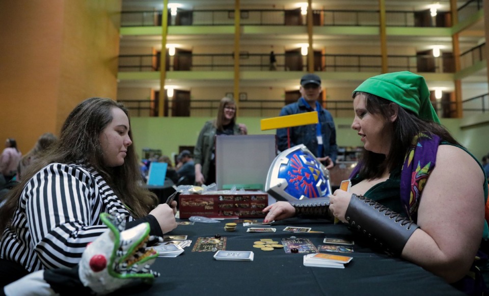 <strong>Kim Jones, dressed as Link, and her daughter Annabelle Jones, dressed as Beetlejuice, play a game of Red Dragon Inn at MidSouthCon.</strong> (Patrick Lantrip/Daily Memphian)
