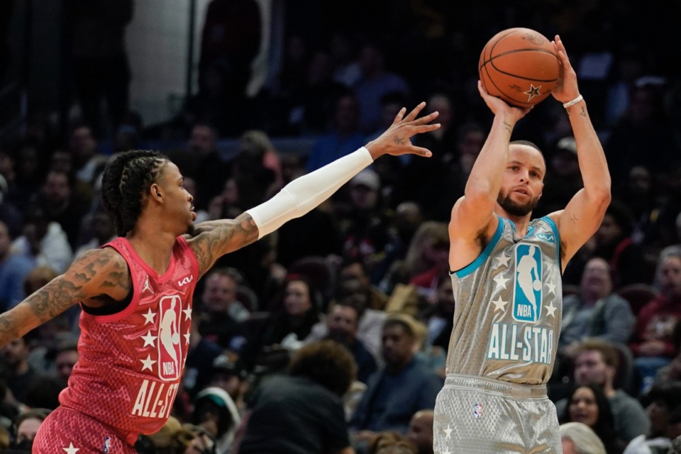 <strong>Golden State Warriors' Stephen Curry, right, shoots for three as Memphis Grizzlies' Ja Morant defends during the second half of the NBA All-Star basketball game, Sunday, Feb. 20, 2022, in Cleveland.</strong> (AP Photo/Charles Krupa)