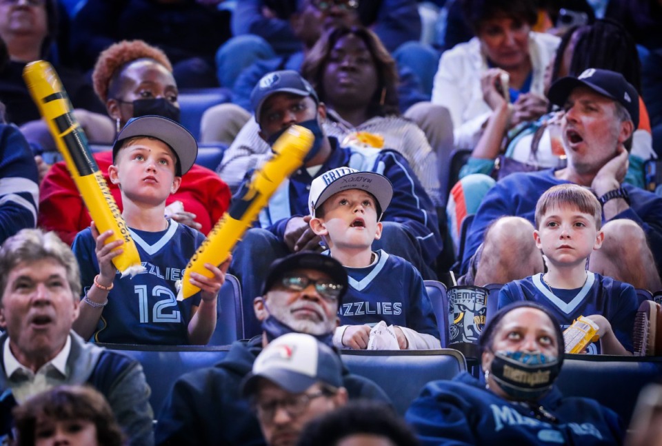 <strong>Grizzlies fans (left to right) Wesley Van Benschoten (9), Maddox Hehe (8) and Jake Kemp (10) watch Memphis wallop Golden State on Monday, March 28, 2022, at FedExForum.</strong> (Mark Weber/The Daily Memphian)