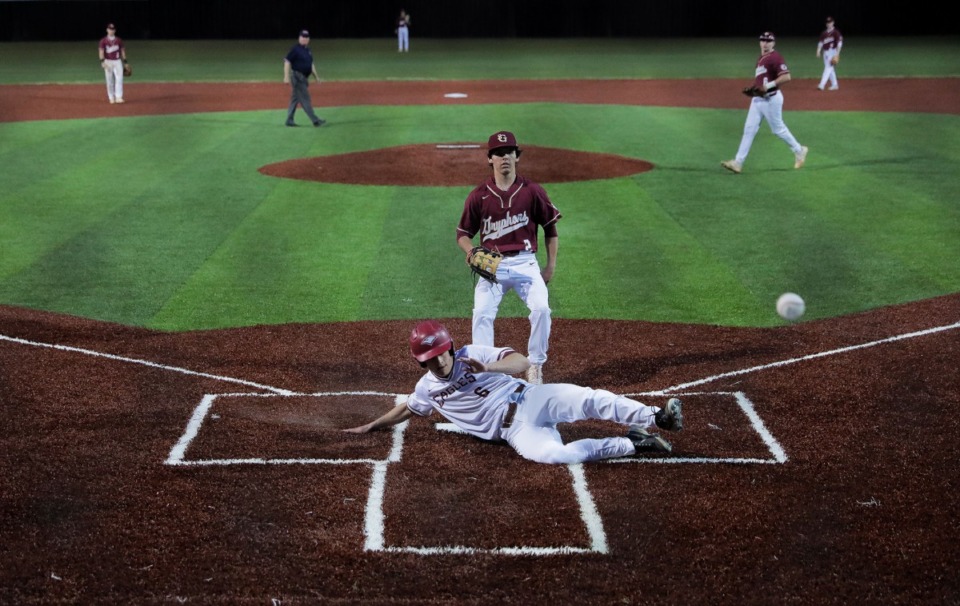<strong>ECS's Zach Baker (6) steals home on an errant pitch during the game against St. George's on March 29.</strong> (Patrick Lantrip/Daily Memphian)