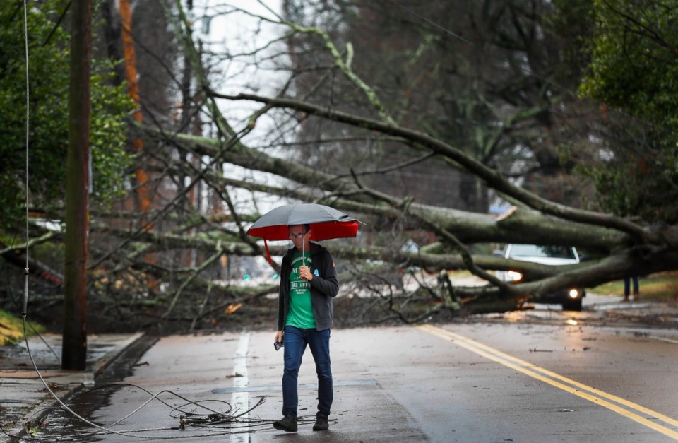<strong>Mark Parrish surveys the damage of a fallen tree on McLean after high winds and heavy rains that hit the area in the early morning hours of Saturday, Jan. 11, 2020.</strong> (Mark Weber/Daily Memphian file)