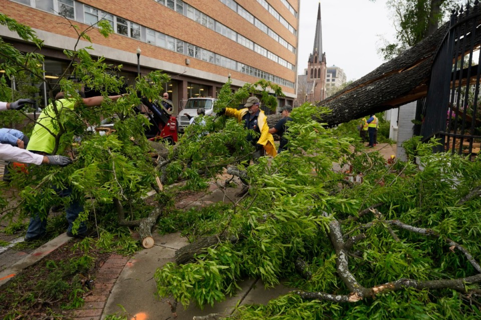 <strong data-stringify-type="bold">Workers clear debris from a downed tree on the grounds of the Mississippi Governor&rsquo;s Mansion after an outbreak of severe weather on Wednesday, March 30.&nbsp;</strong>(AP Photo/Rogelio V. Solis)
