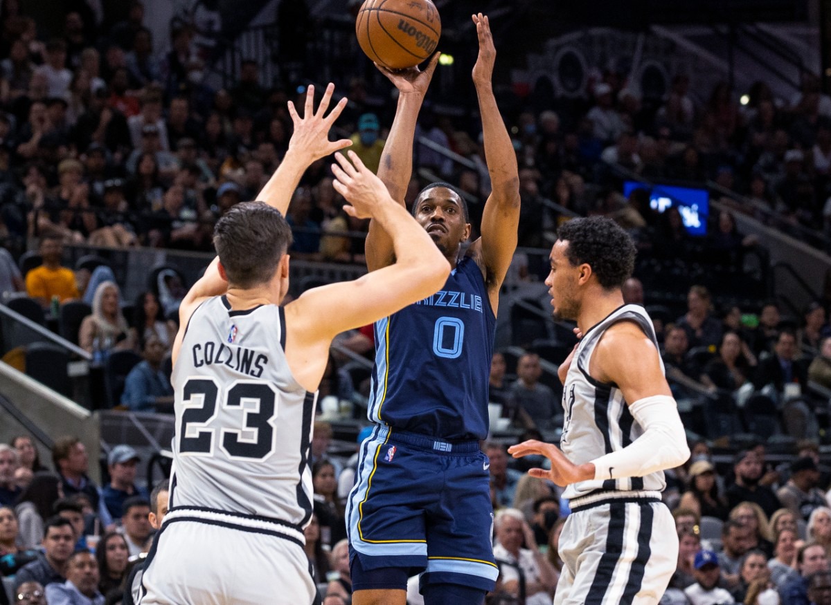 <strong>Memphis Grizzlies guard De'Anthony Melton (0) shoots over San Antonio Spurs forward Zach Collins (23)</strong>&nbsp;<strong>on March 30, 2022, in San Antonio.</strong> (Nick Wagner/AP)