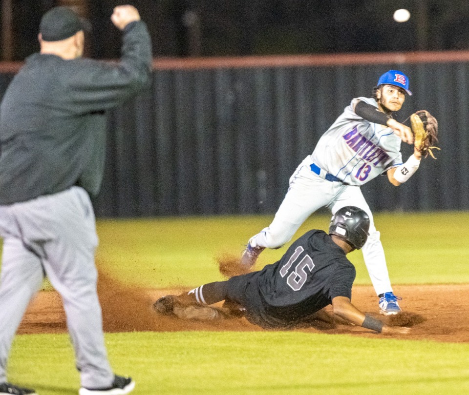 <strong>Bartlett second baseman Jacob Holley throws to first base for a double play after Houston outfielder Donavan Mitchell is called out during Monday's game at Houston High School. (</strong>Greg Campbell/Special to The Daily Memphian)