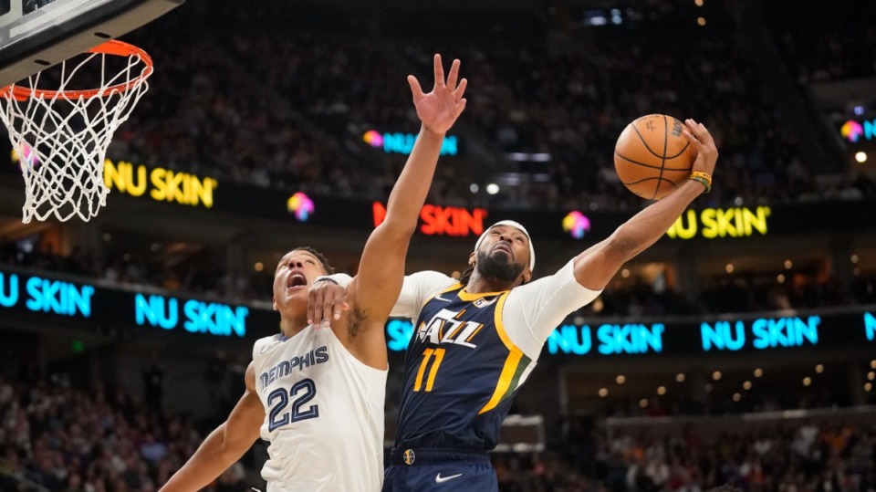 <strong>Utah Jazz guard Mike Conley (11) pulls down a rebound as Memphis Grizzlies guard Desmond Bane (22) defends on April 5, 2022, in Salt Lake City.</strong> (Rick Bowmer/AP)