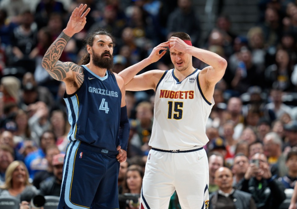 <strong>Grizzlies center Steven Adams, left, signals the refs as Denver Nuggets center Nikola Jokic covers the injury to his right temple on April 7 in Denver.</strong> (David Zalubowski/AP)