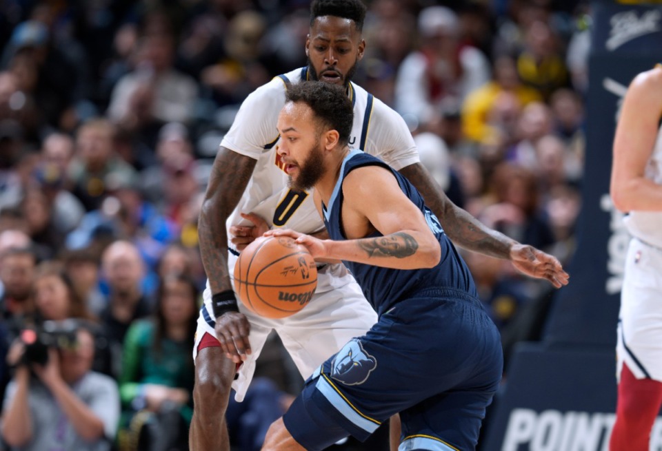 <strong>Memphis Grizzlies forward Kyle Anderson, front, drives on Denver Nuggets forward JaMychal Green on April 7 in Denver.</strong> (David Zalubowski/AP)