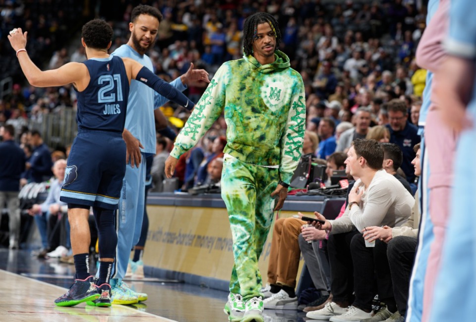 <strong>Injured Memphis Grizzlies guard Ja Morant heads to the bench before the team's NBA basketball game against the Denver Nuggets on April 7 in Denver.</strong> (David Zalubowski/AP)