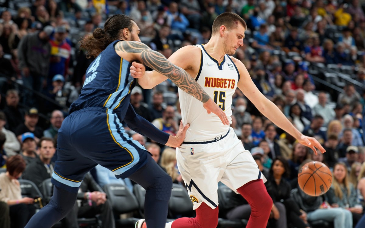 <strong>Memphis Grizzlies center Steven Adams, left, and Denver Nuggets center Nikola Jokic reach for the ball on April 7 in Denver.</strong> (David Zalubowski/AP)