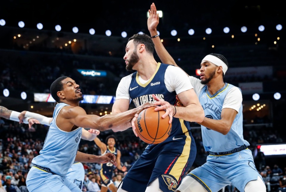 <strong>Memphis Grizzlies defender De'Anthony Melton (left) knocks the ball away from New Orleans Pelicans forward Larry Nance Jr. (middle) as teammate Ziaire Williams (right) helps on the play during action on Saturday, April 9, 2022</strong>. (Mark Weber/The Daily Memphian)
