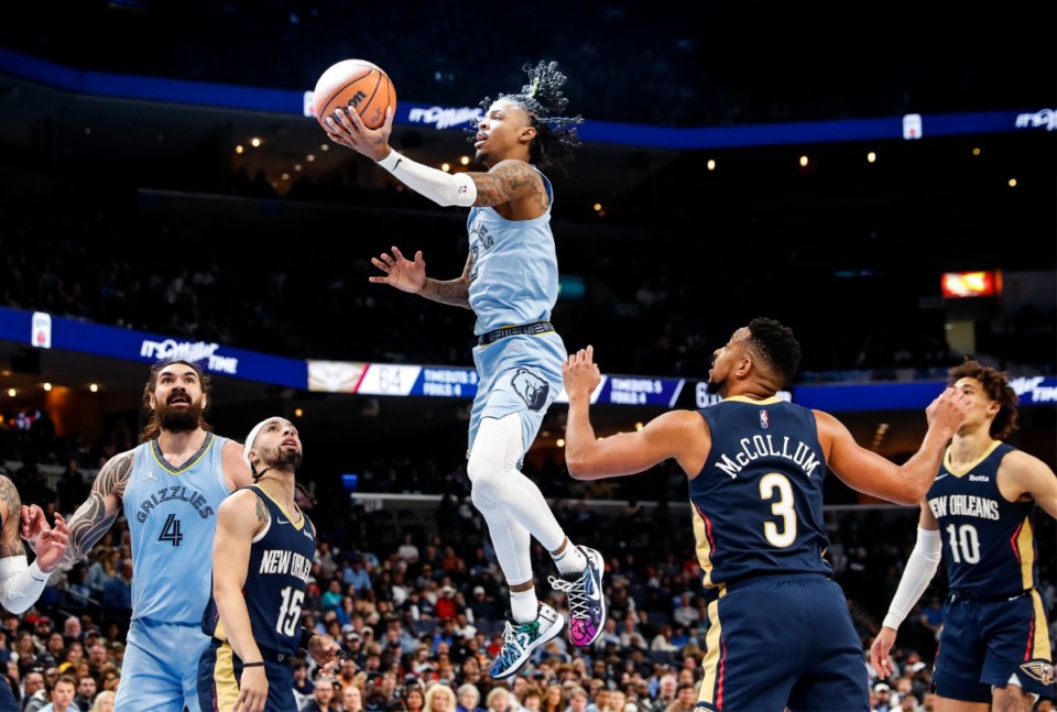 <strong>Memphis Grizzlies guard Ja Morant (middle) drives for a basket against the New Orleans Pelicans during action on Saturday, April 9, 2022.</strong> (Mark Weber/The Daily Memphian)